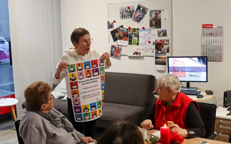 Rottraut Lampe (re.), Besucherin des Quartiersbüros, ist ebenfalls mit einem Foto auf dem Caritas-Plakat vertreten.