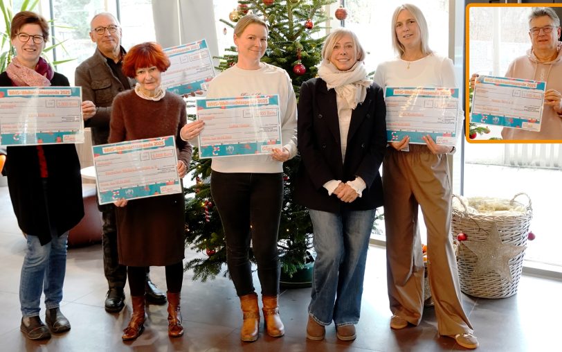 Bei der Übergabe der WHS-Weihnachtsspende 2025: (v.li.) Margret Springkämper (CVJM), Frank Obenlüneschloß (Förderverein Palliativstation im EvK Herne), Rosemarie Nowak (Kinderschutzbund Herne), Linda Schultz (Lukas-Hospiz), Simone Hitzler (WHS-Vorstand), Klara Kraatz (Ev. Kinderheim Herne & Wanne-Eickel). In der Box Torsten Biermann (Herner Tafel).