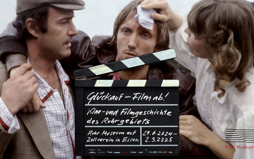 Ein Szenenfoto zur in Herne uraufgeführten Revierkomödie „Theo gegen den Rest der Welt“ ziert das Plakat der Ausstellung „Glückauf – Film ab!“ auf Zollverein. Sie wird am 24. November 2014 im Essener Filmstudio Glückauf wieder gezeigt.