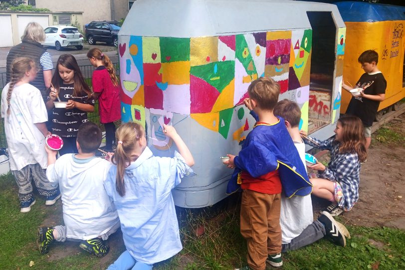 Malaktion HKB mit Schülern der Grundschule Vellwigstraße – gemeinsam bemalten sie eine alte Zechenlore, die auf dem Spielplatz im Kunstwald Teutoburgia steht.