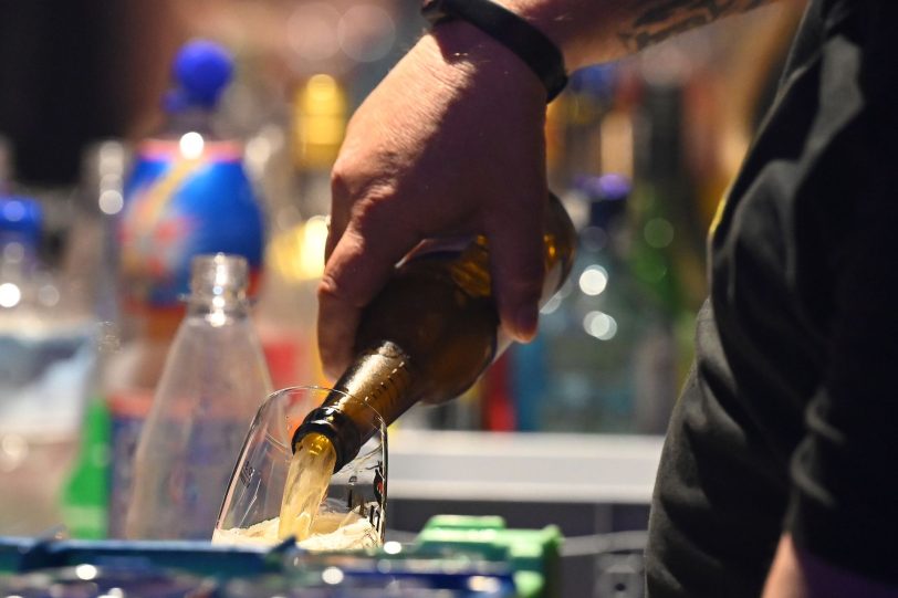 Zwei Getränketheken versorgten die Gäste in der großen Halle mit Getränken. Hier schüttet ein Mitarbeiter ein Bier ein.