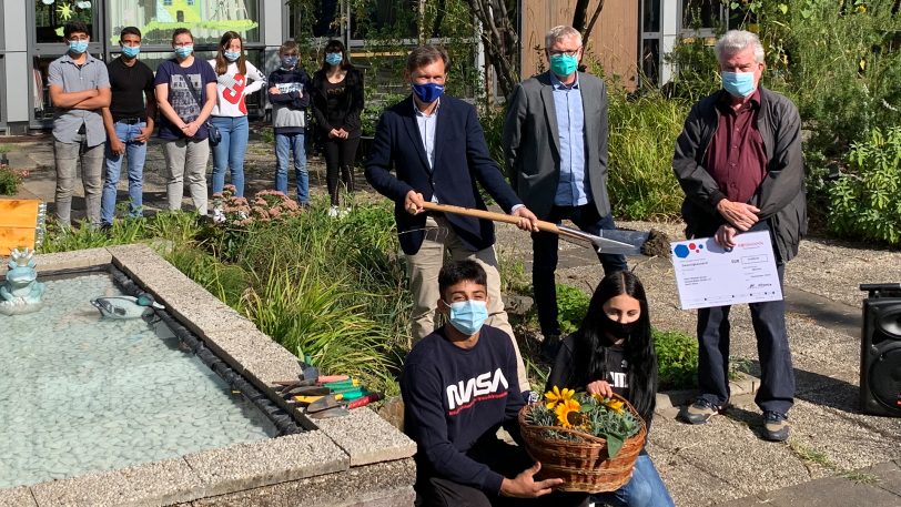 Schüler und Verantwortliche zusammen vor dem Gartenteich: vorne (v.li.) Yousef und Gina, Mitte (v.li.) OB Dr. Frank Dudda, Schulleiter Lothar Heistermann und Michael Kruse, Regional-Koordinator des Deutschen Kinderhilfswerkes.