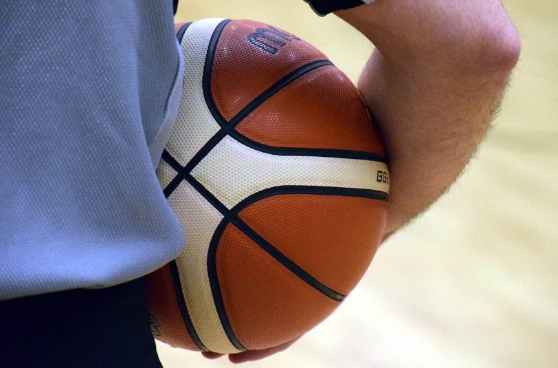 Basketball in Schiedsrichterhand.